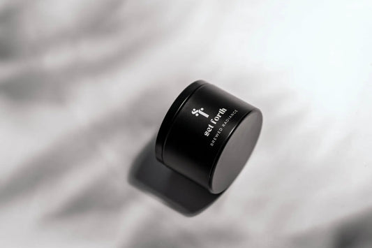 Brewed Radiance candle in matte black tin.