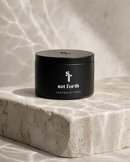 Black container with 'set forth Lustrous Tides' branding on a stone surface