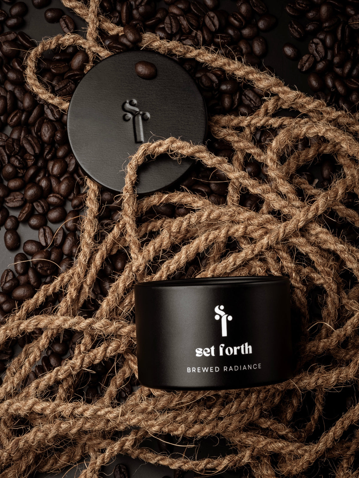 Black tin can with 'set forth' branding on a background of coffee beans and twine.