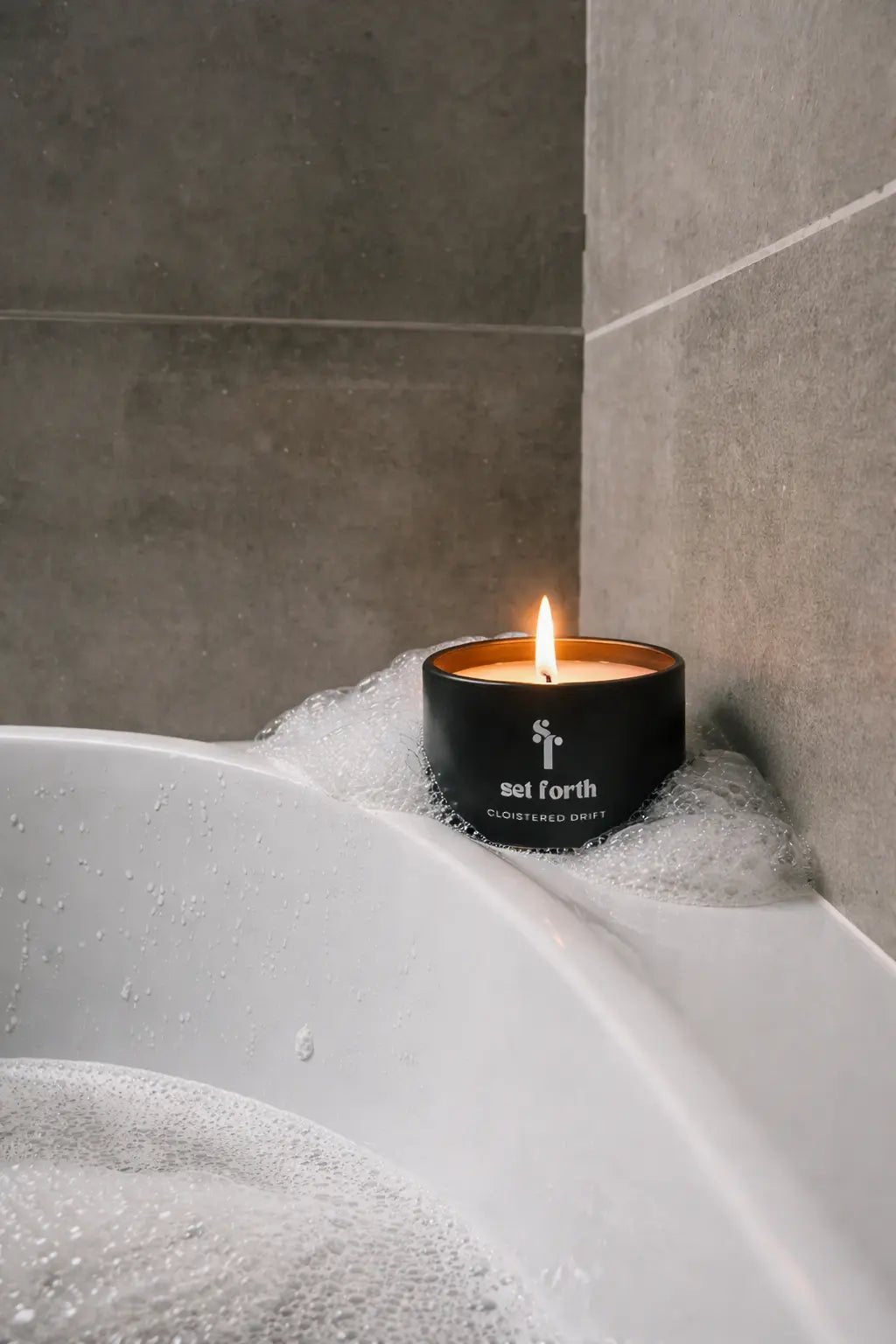 Cloistered Drift candle in matte black tin.