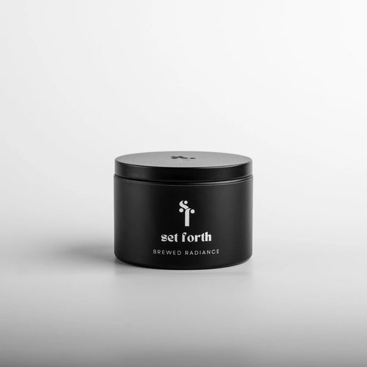 Brewed Radiance candle in matte black tin.